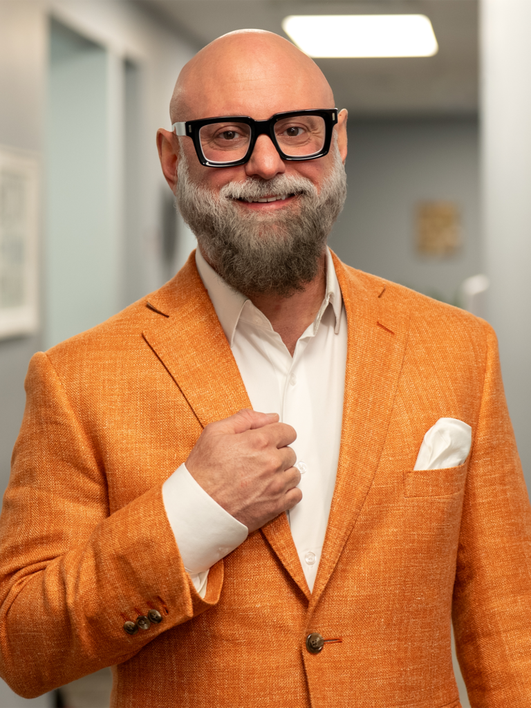 Dr. Hanyon in his dental office with orange suite