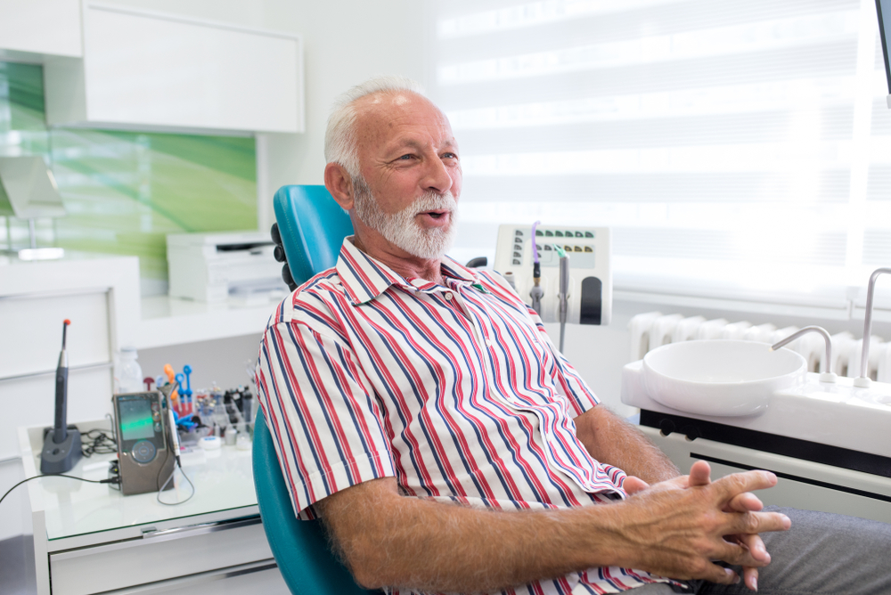 Dentist consulting a patient about a dental implant procedure in a modern clinic.